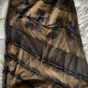 Gold skirt with black sheer overlay with designs